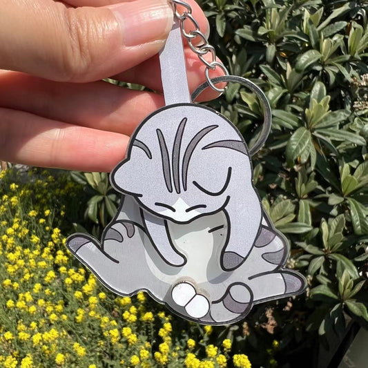 Playing with eggs and kitten keychain